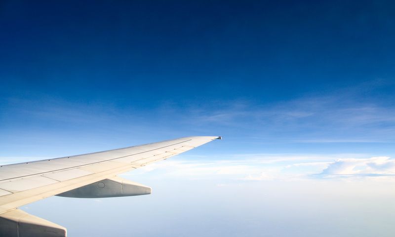 Airplane wing above the clouds