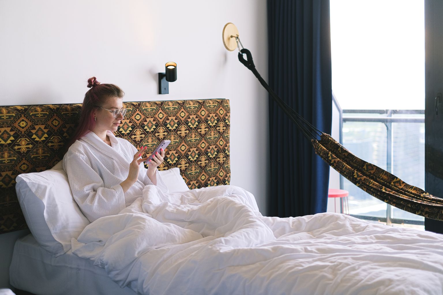 Traveler comparing Booking.com and Hotels.com prices on a phone
