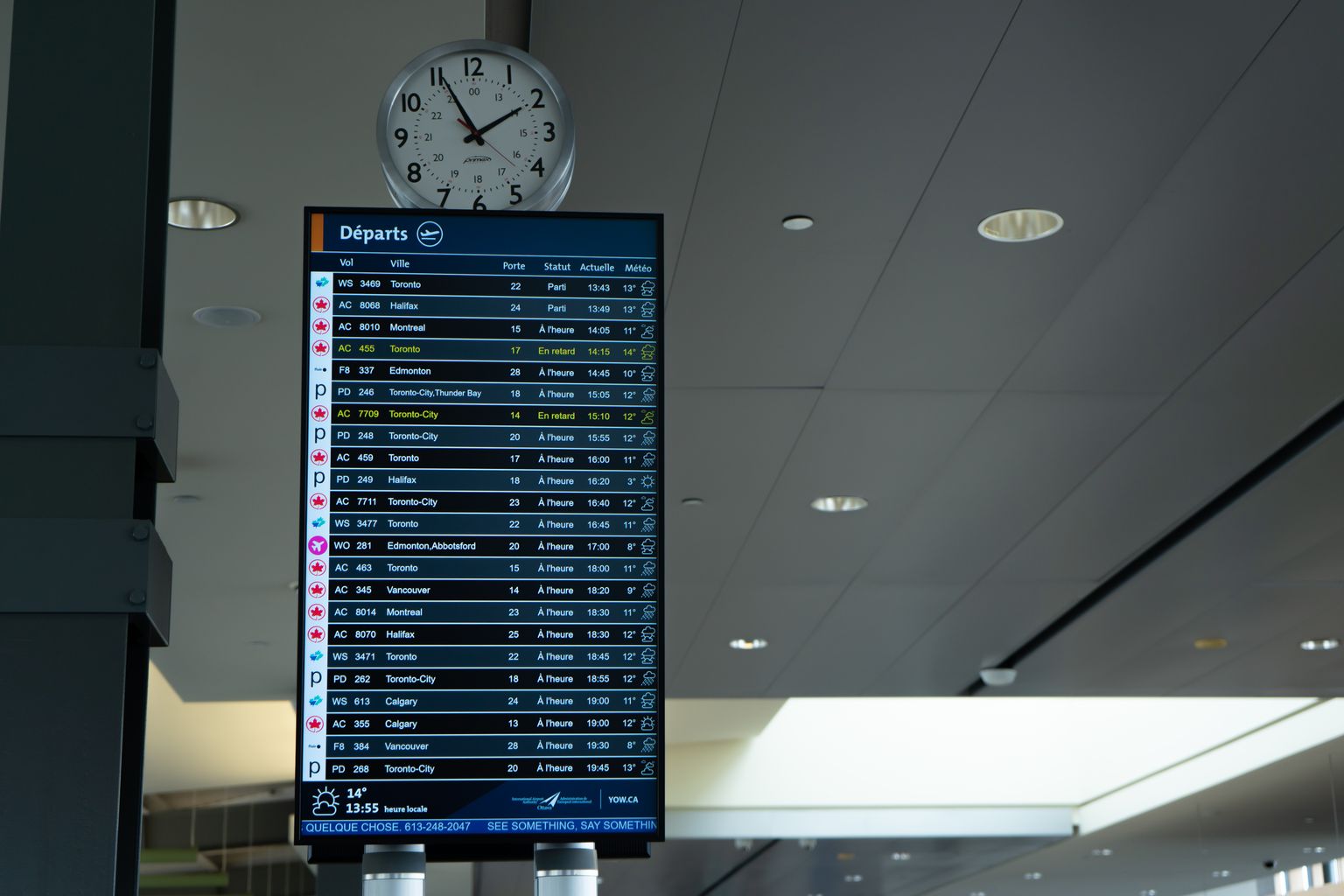 Airport departure board showing last minute flight times